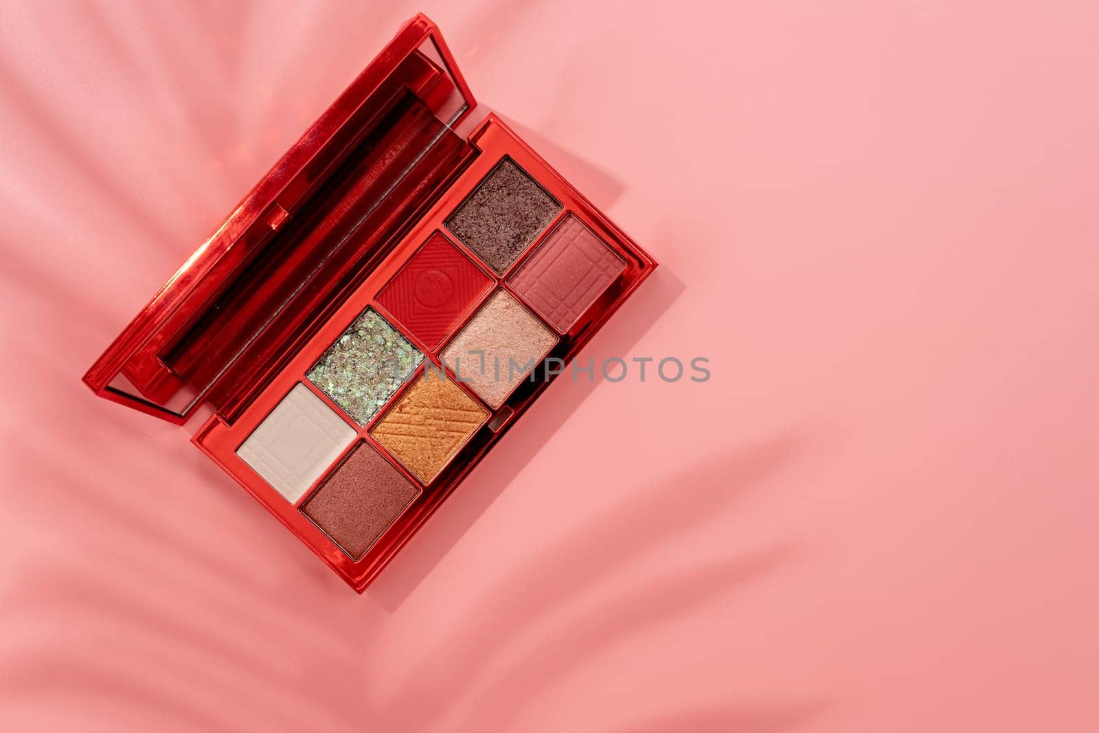 Bright eyeshadow palette closeup with shadow overlay. Makeup cosmetics. Colorful colors. Place for text. Flat lay. Top view. layout