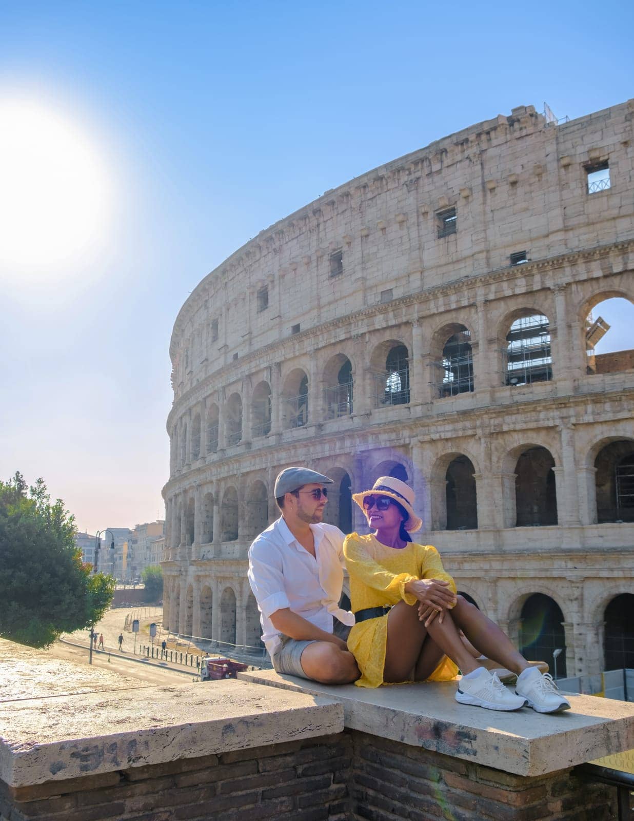 Young couple mid age on a city trip in Rome Italy Europe, Colosseum building in Rome, Italy at summer