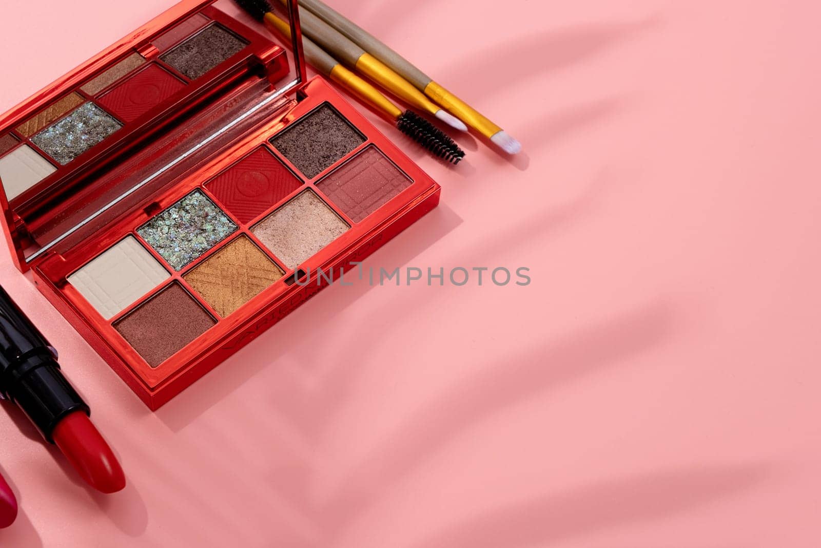 Bright eyeshadow palette closeup with shadow overlay. Makeup cosmetics. Colorful colors. Place for text. Flat lay. Top view. layout