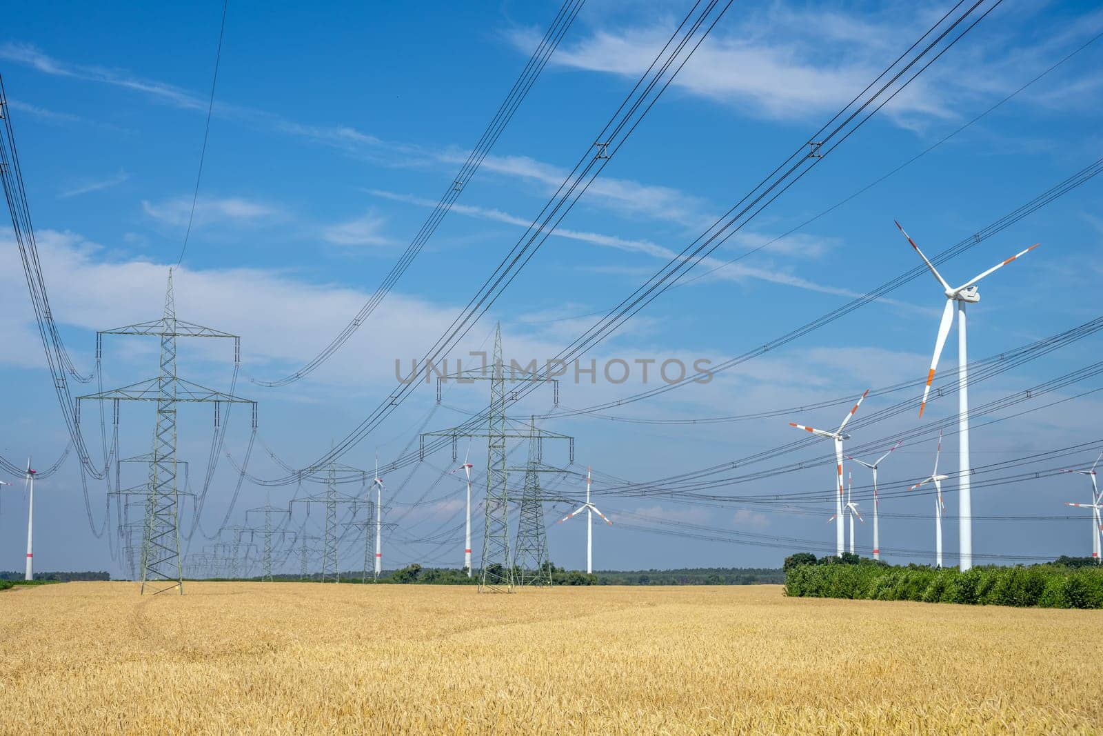 Pylons, power lines and wind turbines seen in an agricultural area in Germany