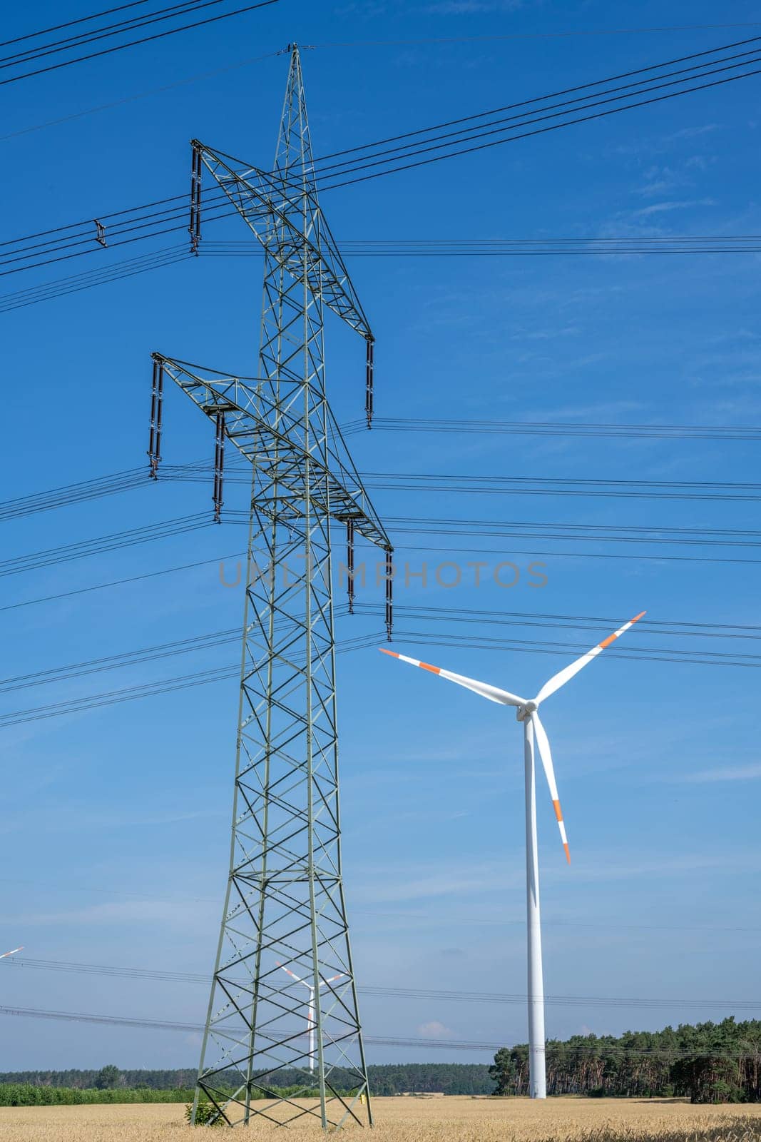 Electricity pylon, wind turbine and power cables by elxeneize