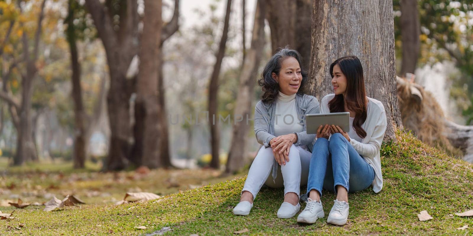 Adult daughter and her elderly mother have outdoor activity together by itchaznong