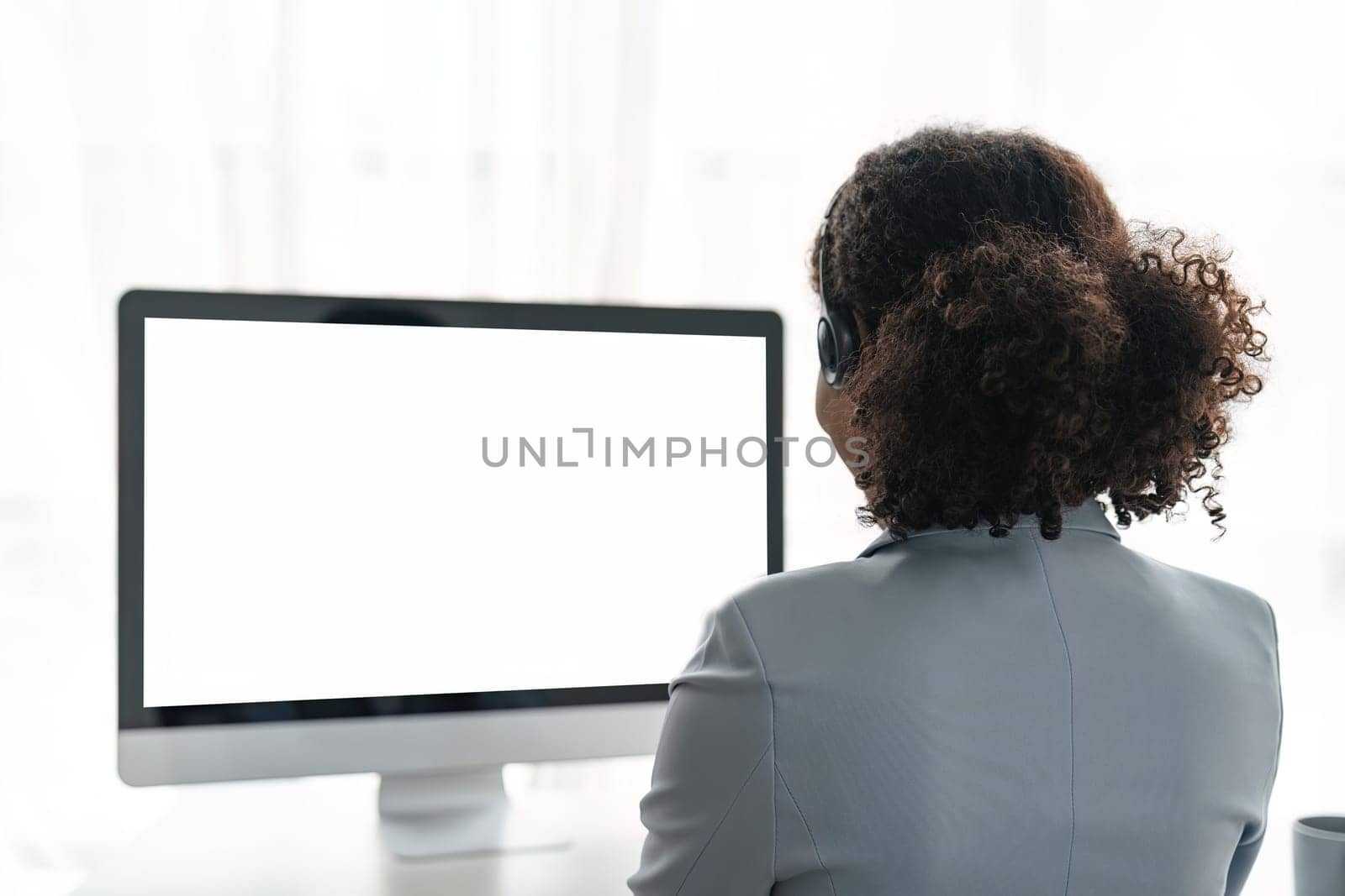 Portrait of happy smiling female customer support phone operator at workplace. Smiling beautiful African American woman working in call center.