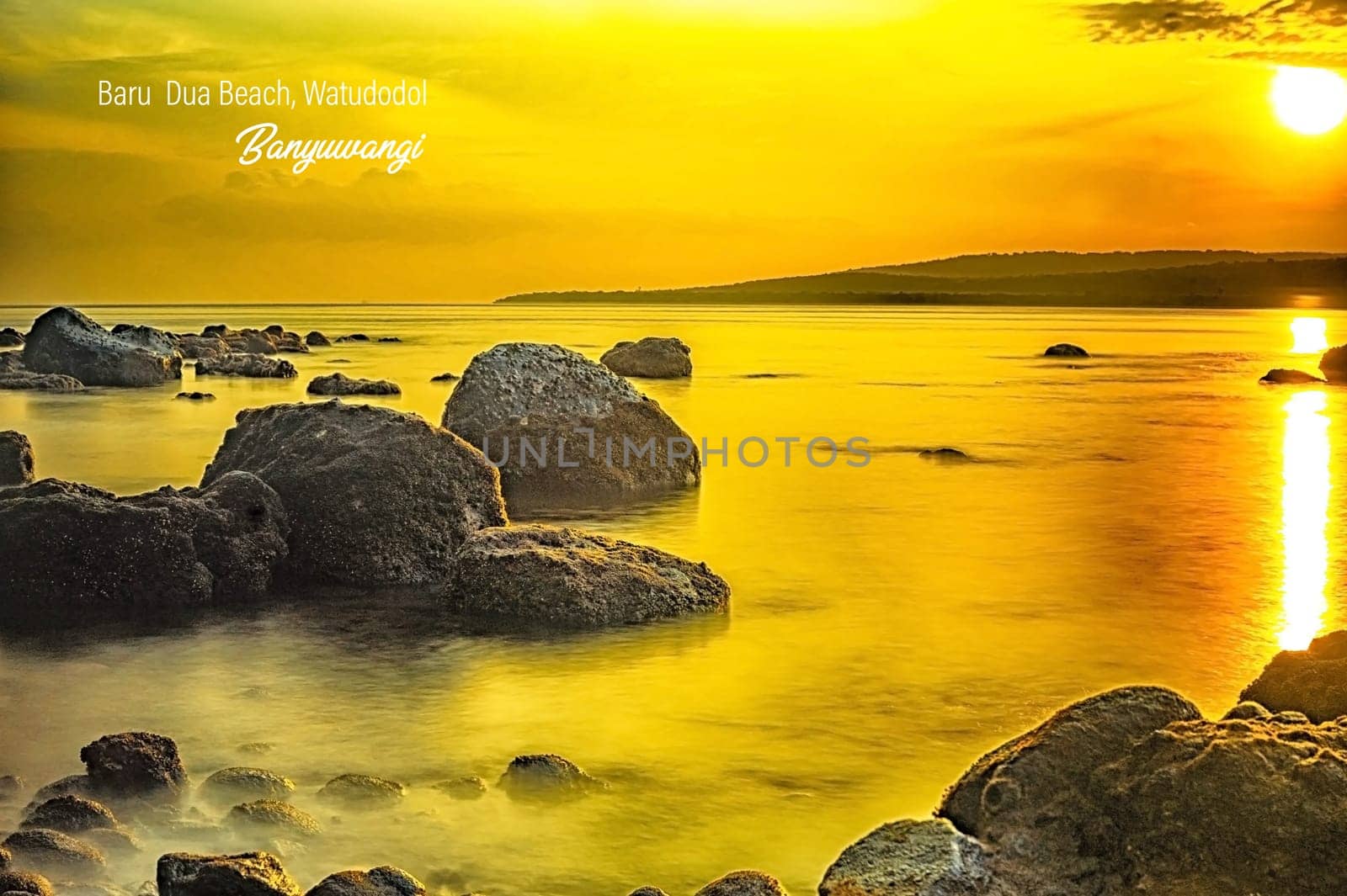 Rocks on the beach during sunrise in Banyuwangi, Indonesia. Long exposure photography. Defocused.