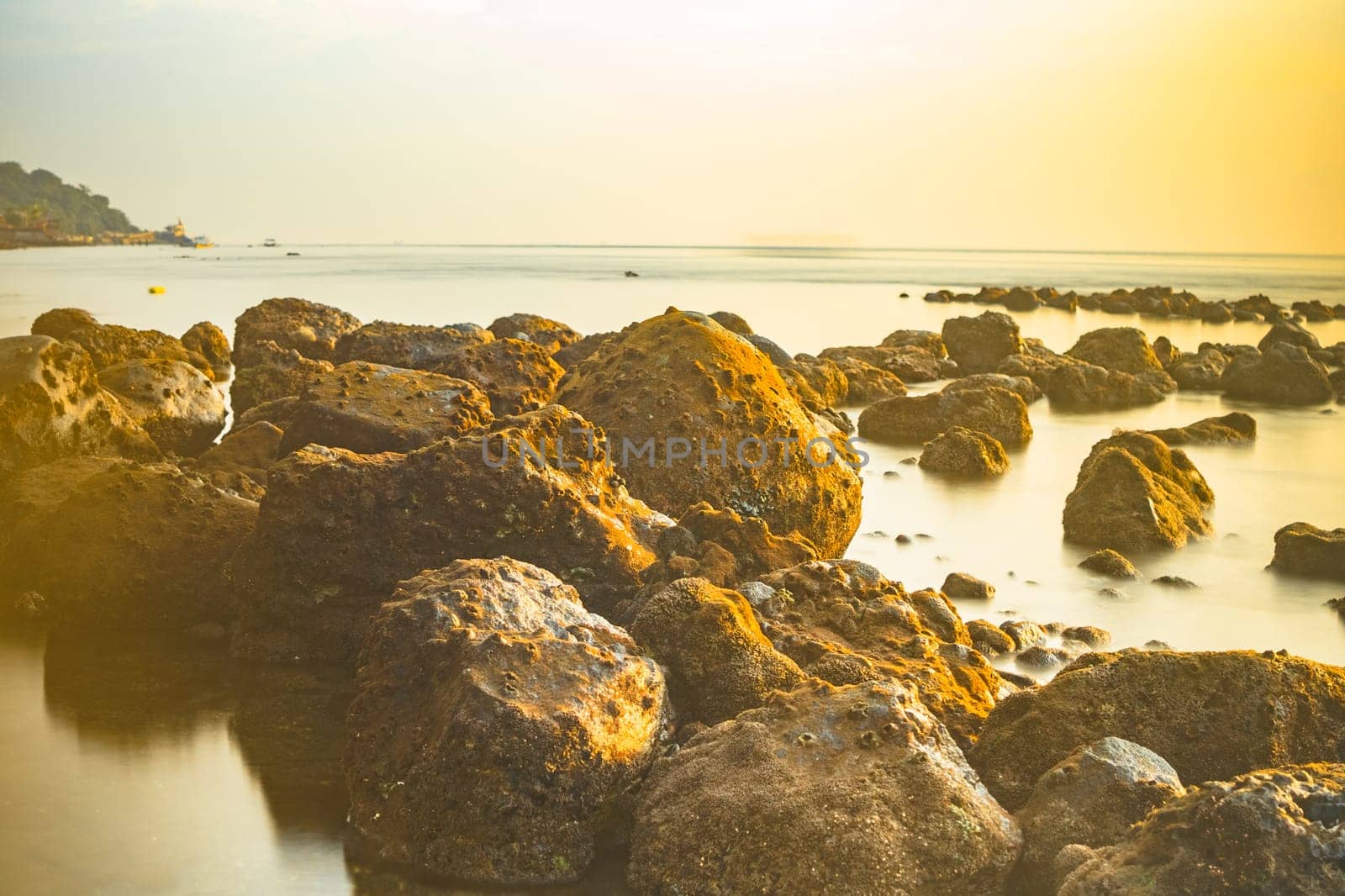 Rocks on the beach during sunrise in Banyuwangi, Indonesia. Long exposure photography. Defocused.
