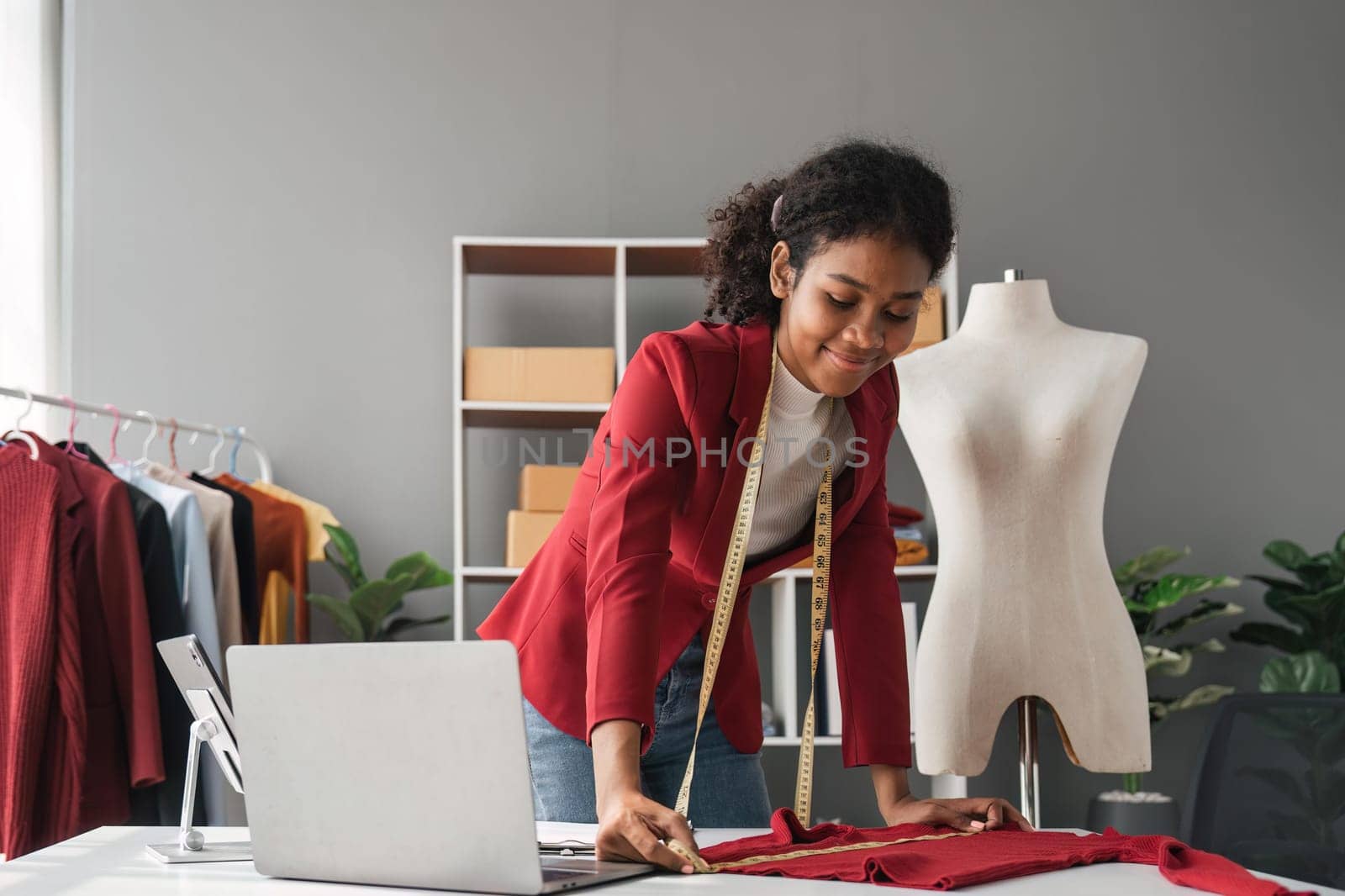 Female stylist Successful Fashion Business. Portrait of Smiling Black Designer stylish standing and working at fashion studio. Portrait of fashion designer in office. by nateemee