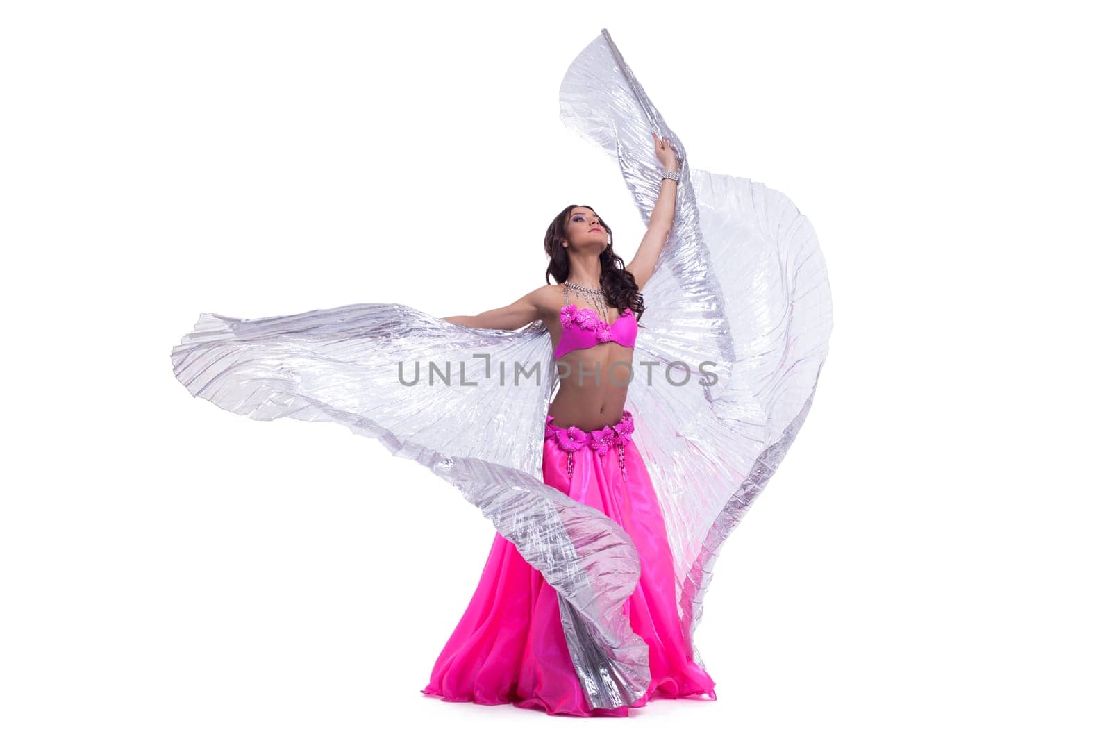 Full length portrait of beautiful dancer performing oriental dance with silver wings isolated