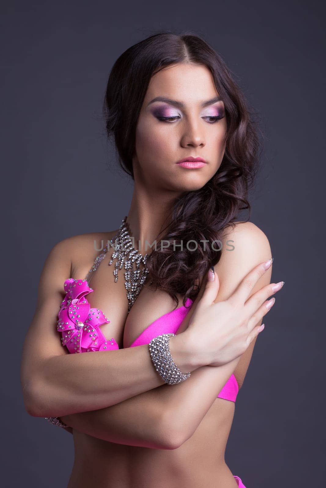 Studio portrait of beautiful dancer in pink oriental costume