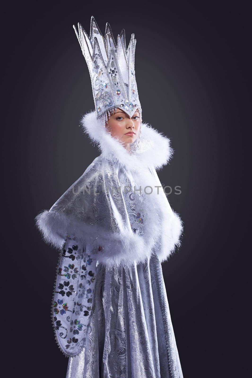 portrait of serious girl stand in ice queen carnival costume