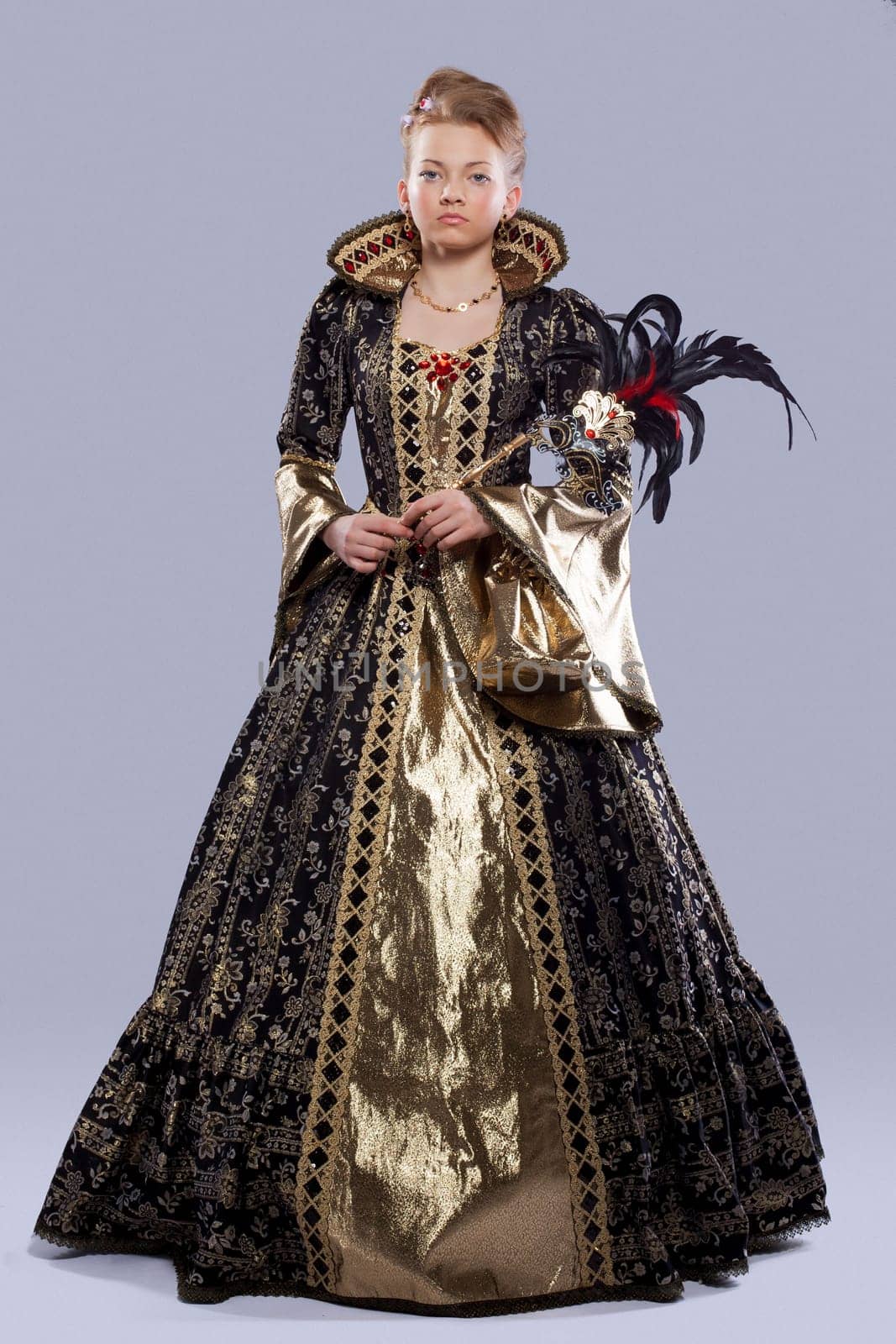 Full length portrait of young girl in carnival costume middle age