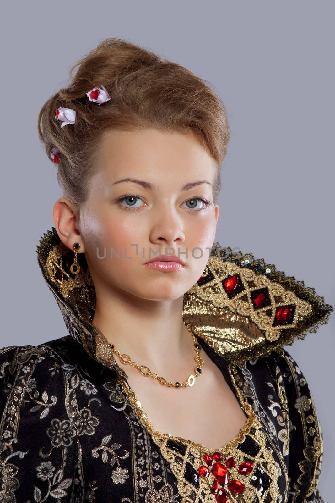 Studio portrait of young woman in carnival dress like princess