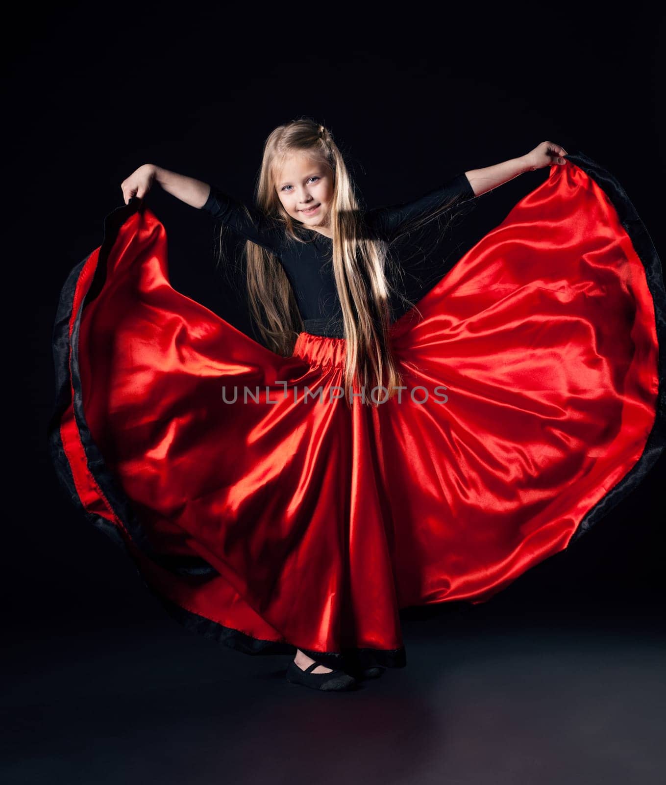 Full length portrait of happy little girl performing hispanic dance