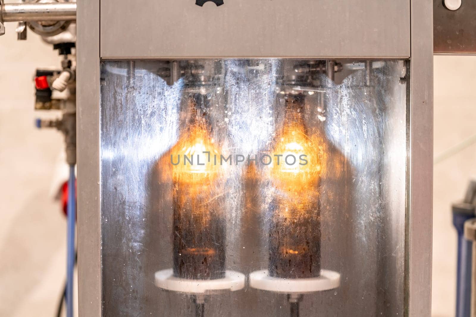 machine for washing and filling glass bottles with beer. High quality photo