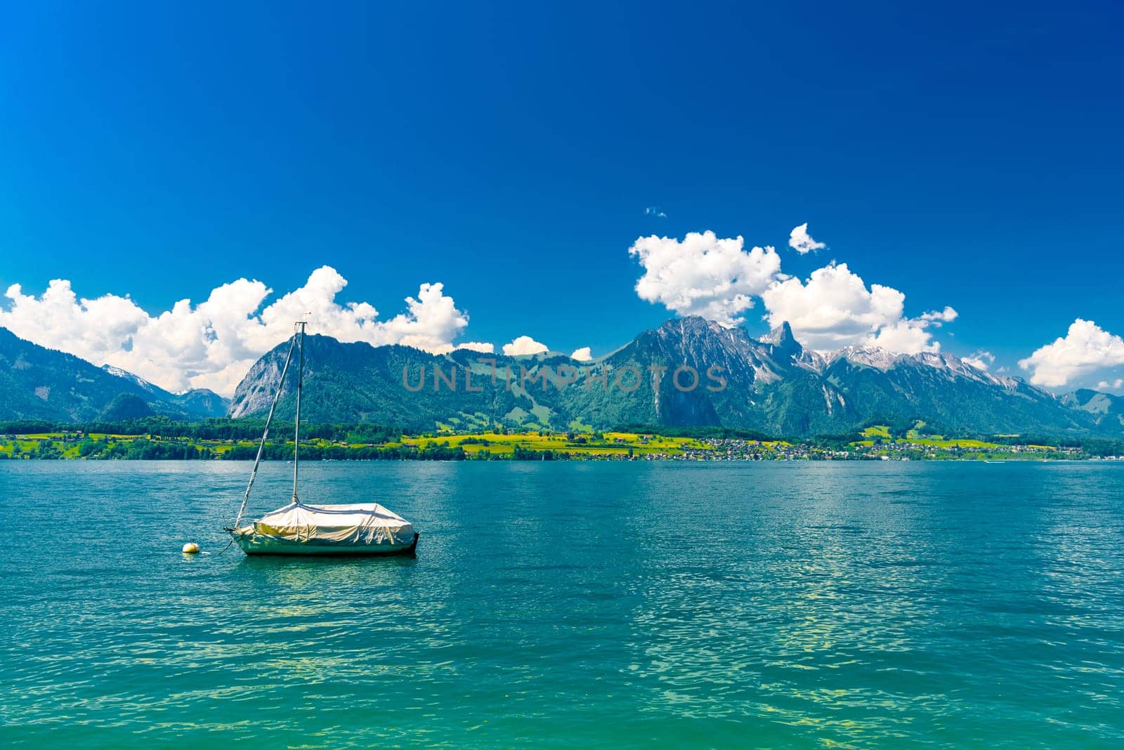 Boats and mountains on the Lake Thun, Thunersee Bern Switzerland.