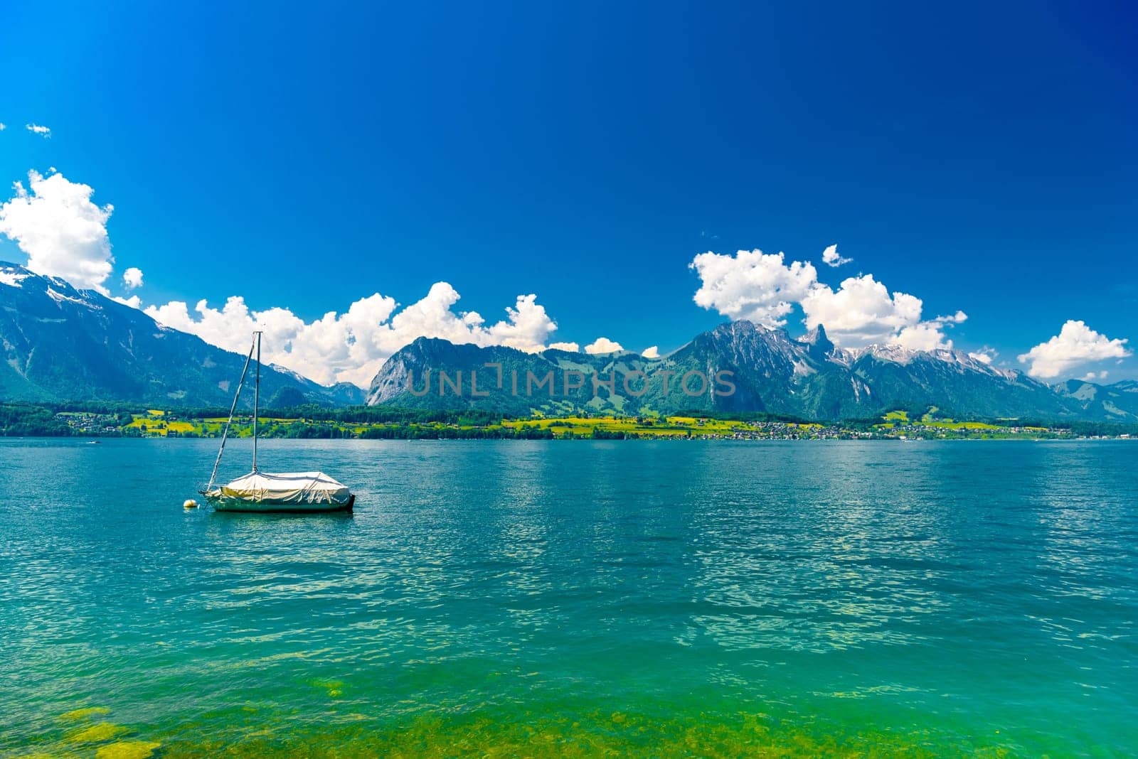 Boats and mountains on the Lake Thun, Thunersee Bern Switzerland.