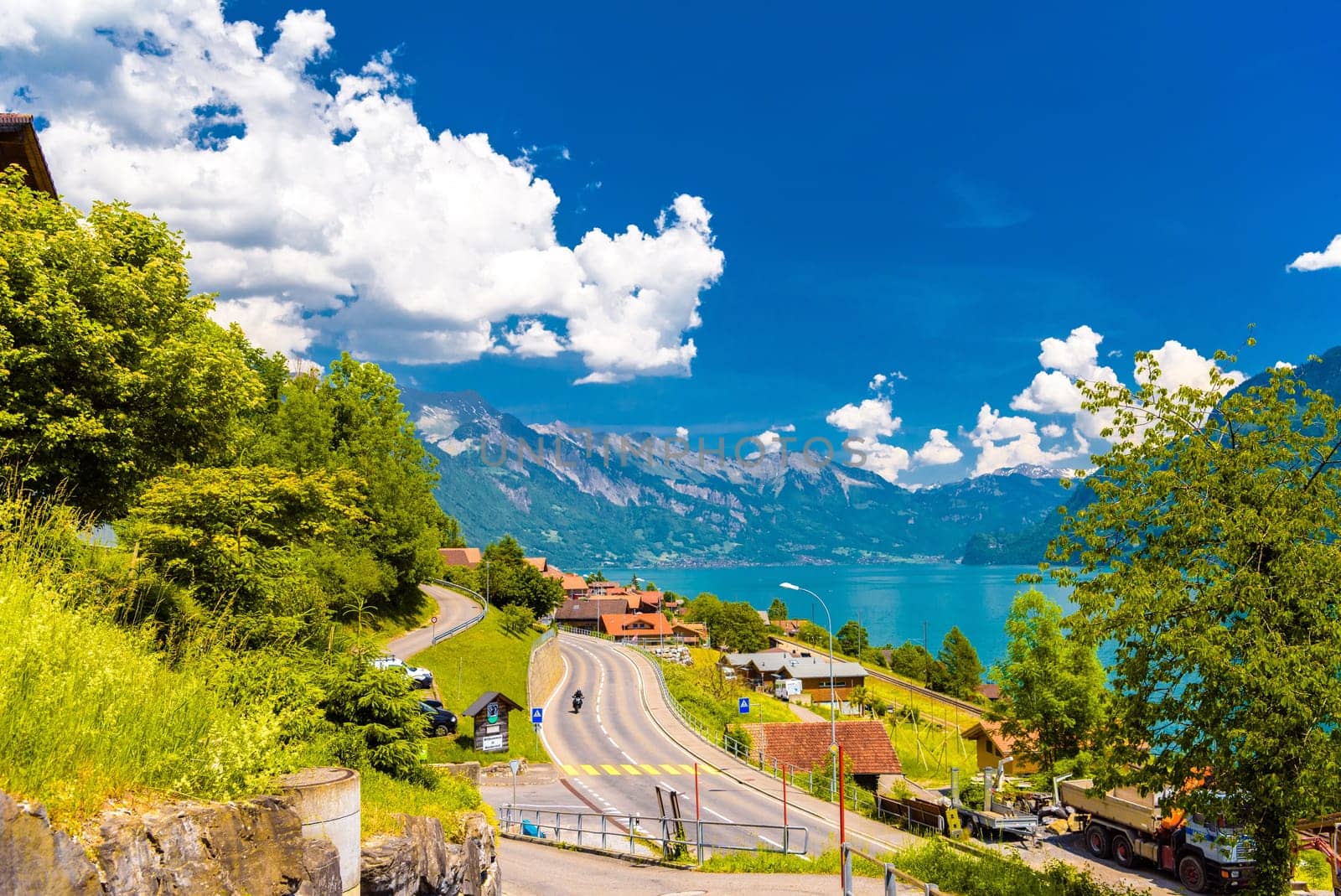 Road in the village and mountains near Lake Brienz, Oberried am by Eagle2308