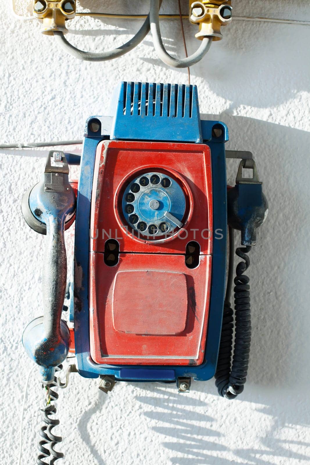 Old rotary phone on wall, close-up