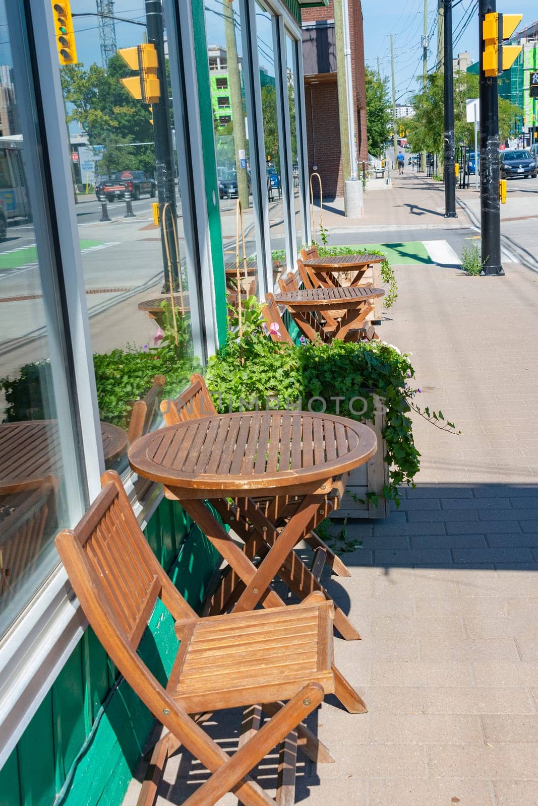 On a sunny summer day, the hosts put tables on the sidewalk near the cafe
