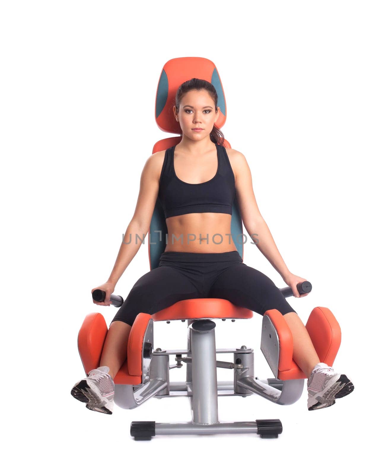 Sporty brunette on modern exerciser isolated on white