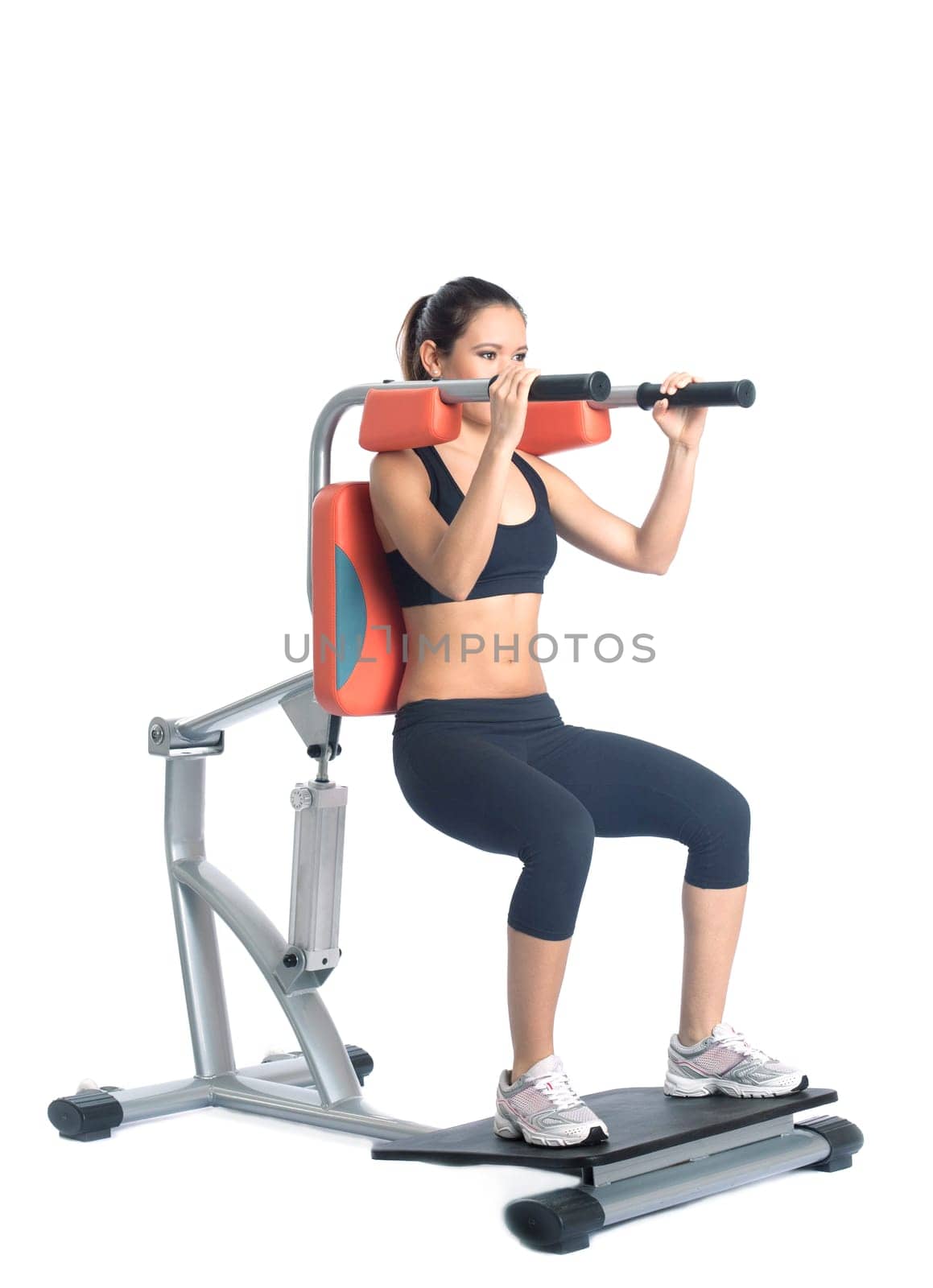 Sporty young woman on isodynamic exerciser. Isolated on white