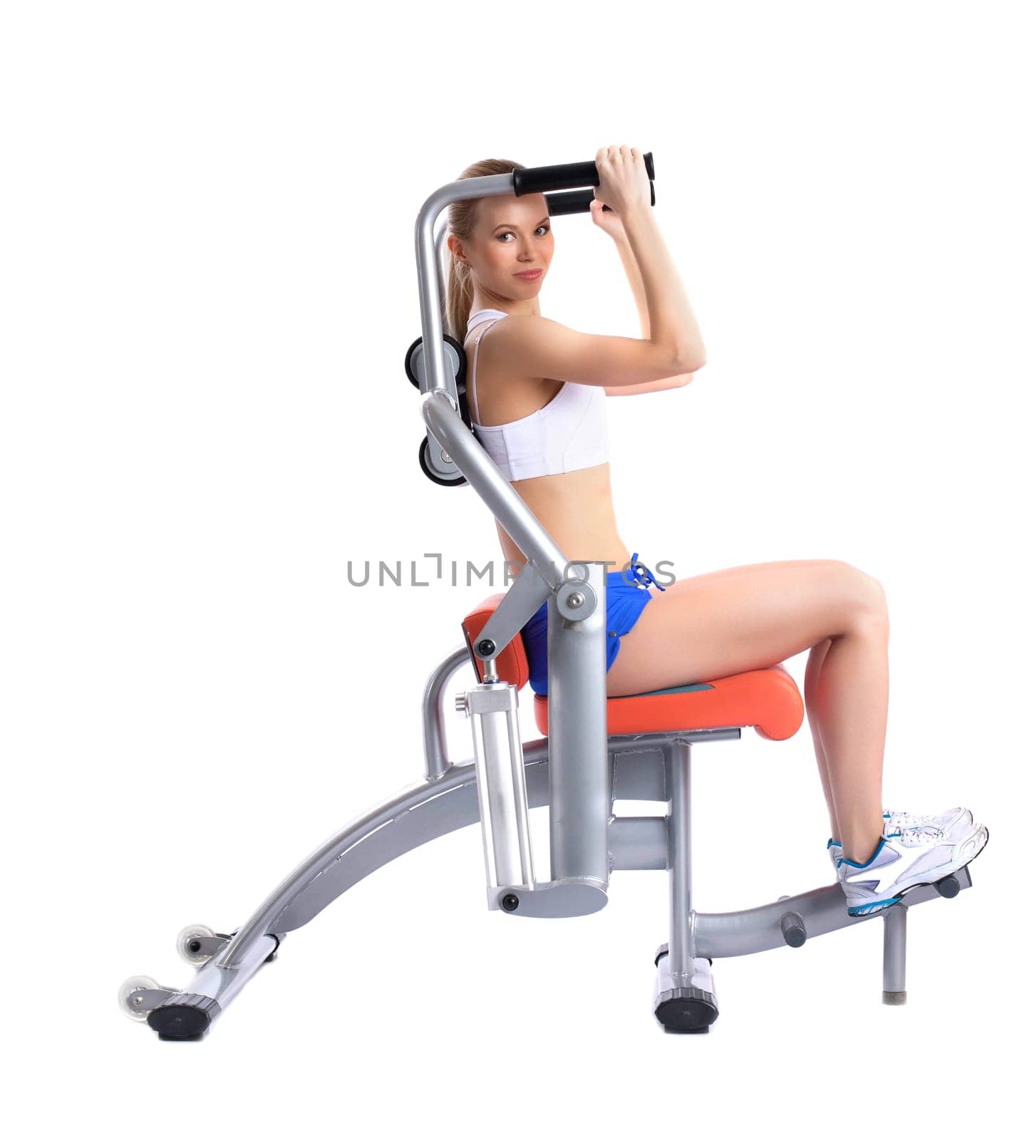 Lovely woman training on hydraulic exerciser, isolated on white