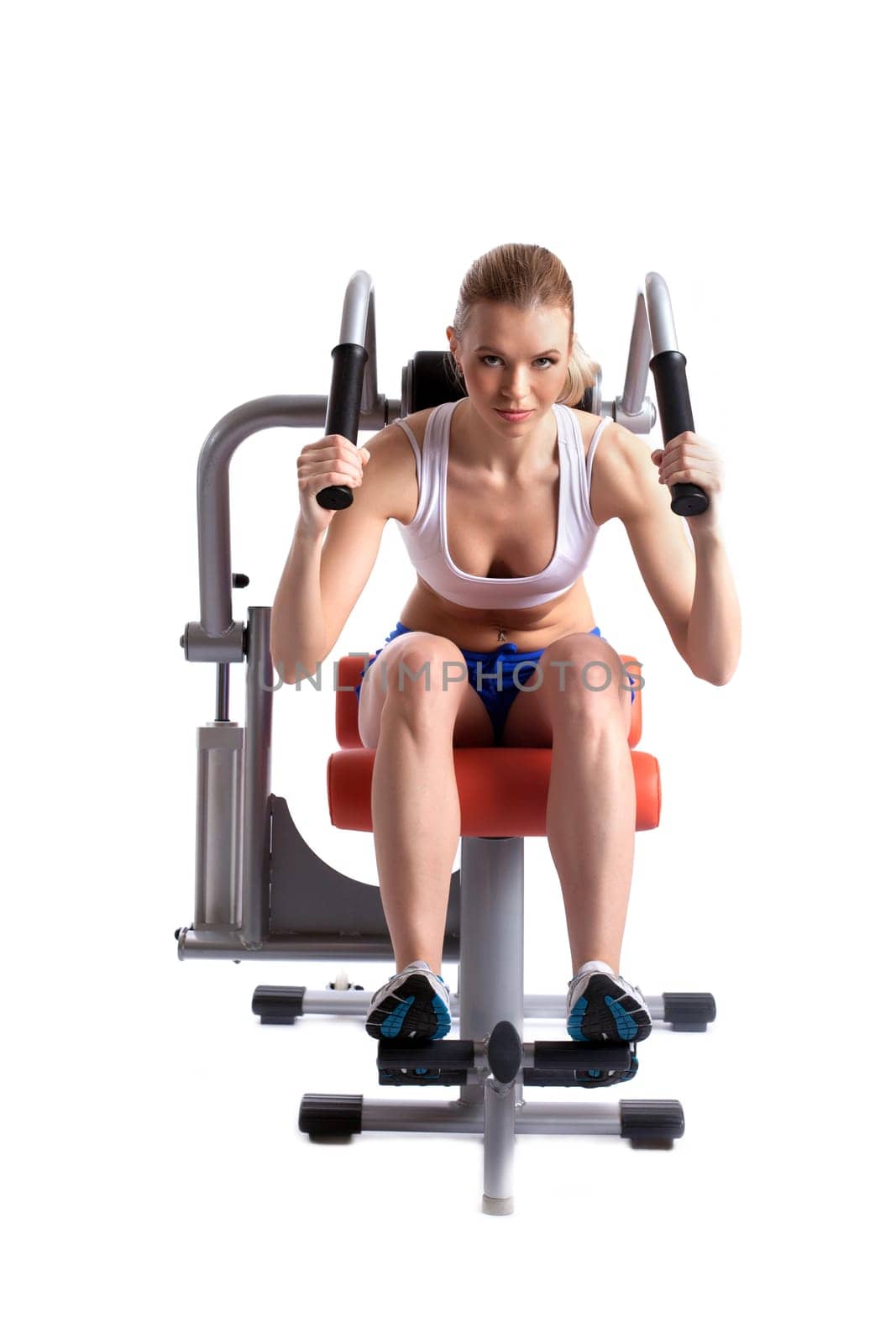 Athletic woman on hydraulic trainer, isolated on white