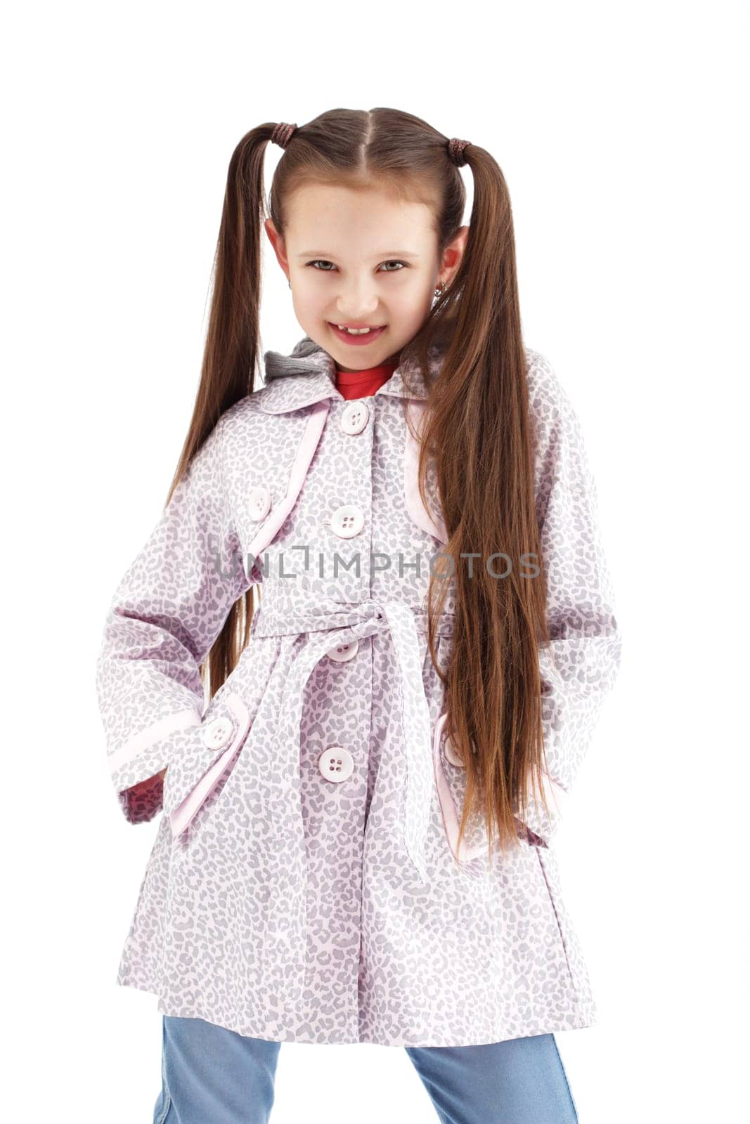 Beautiful little girl posing in fashionable coat, isolated on white