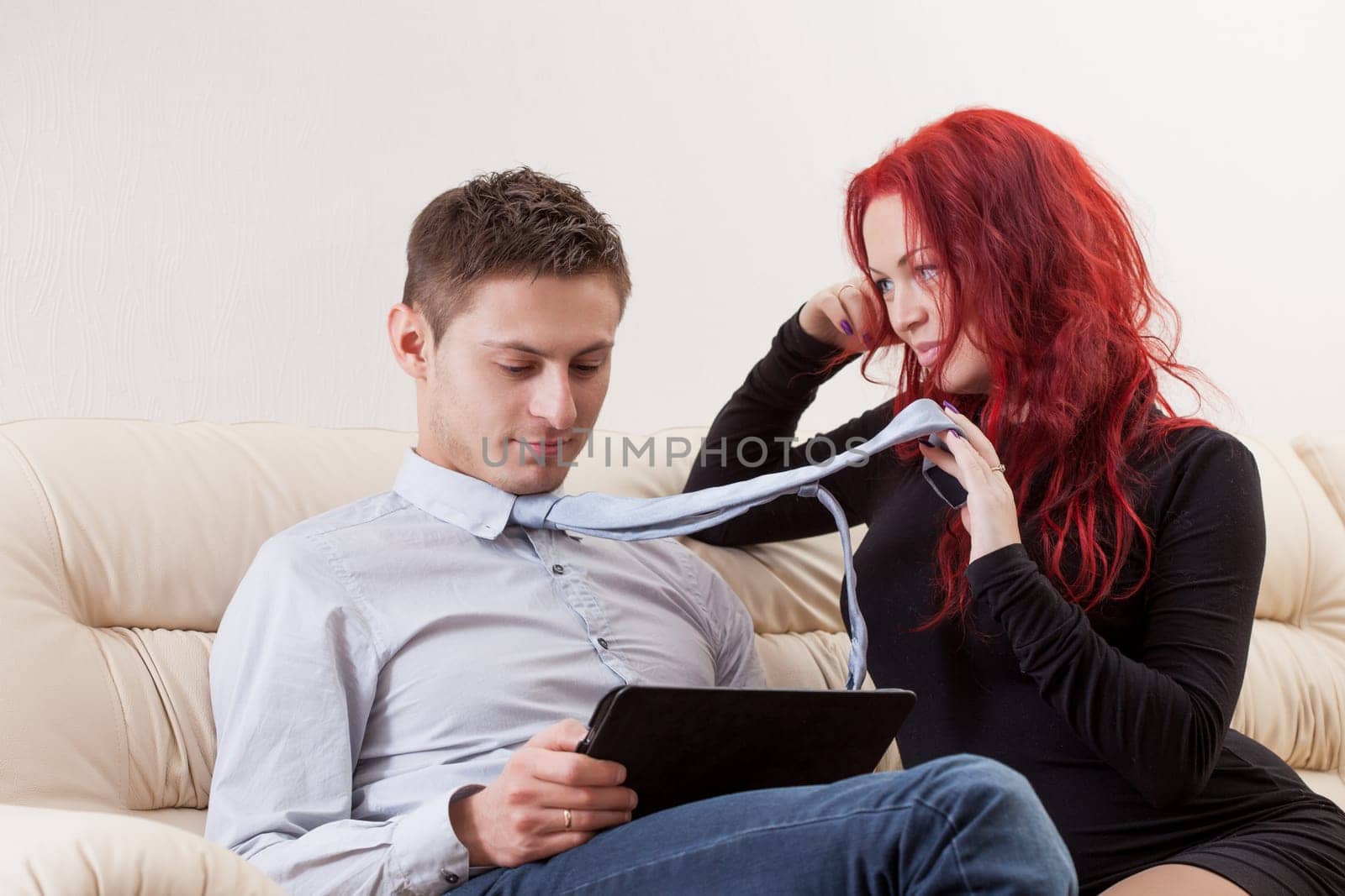Pretty young woman with red hair flirting with man