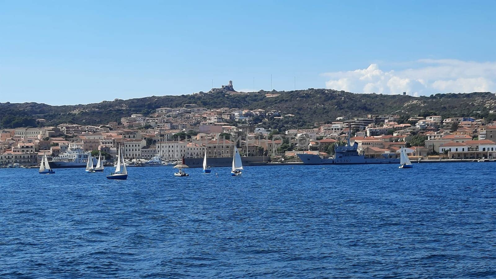 yachts are moored near the sea against the backdrop of mountains in the haze. High quality photo