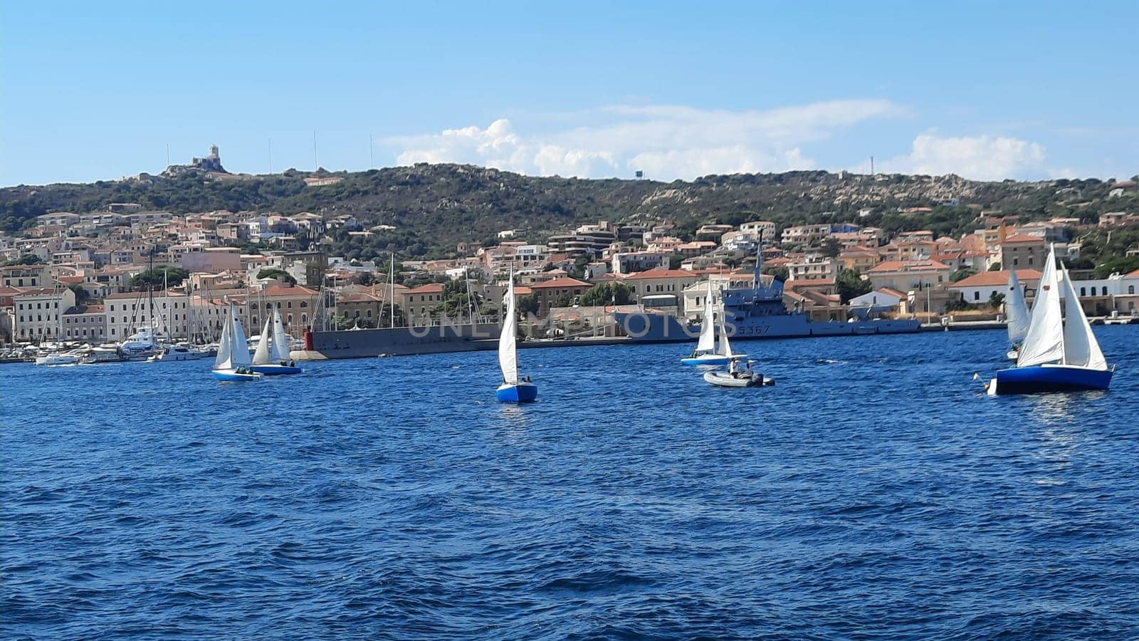 yachts are moored near the sea against the backdrop of mountains in the haze. High quality photo