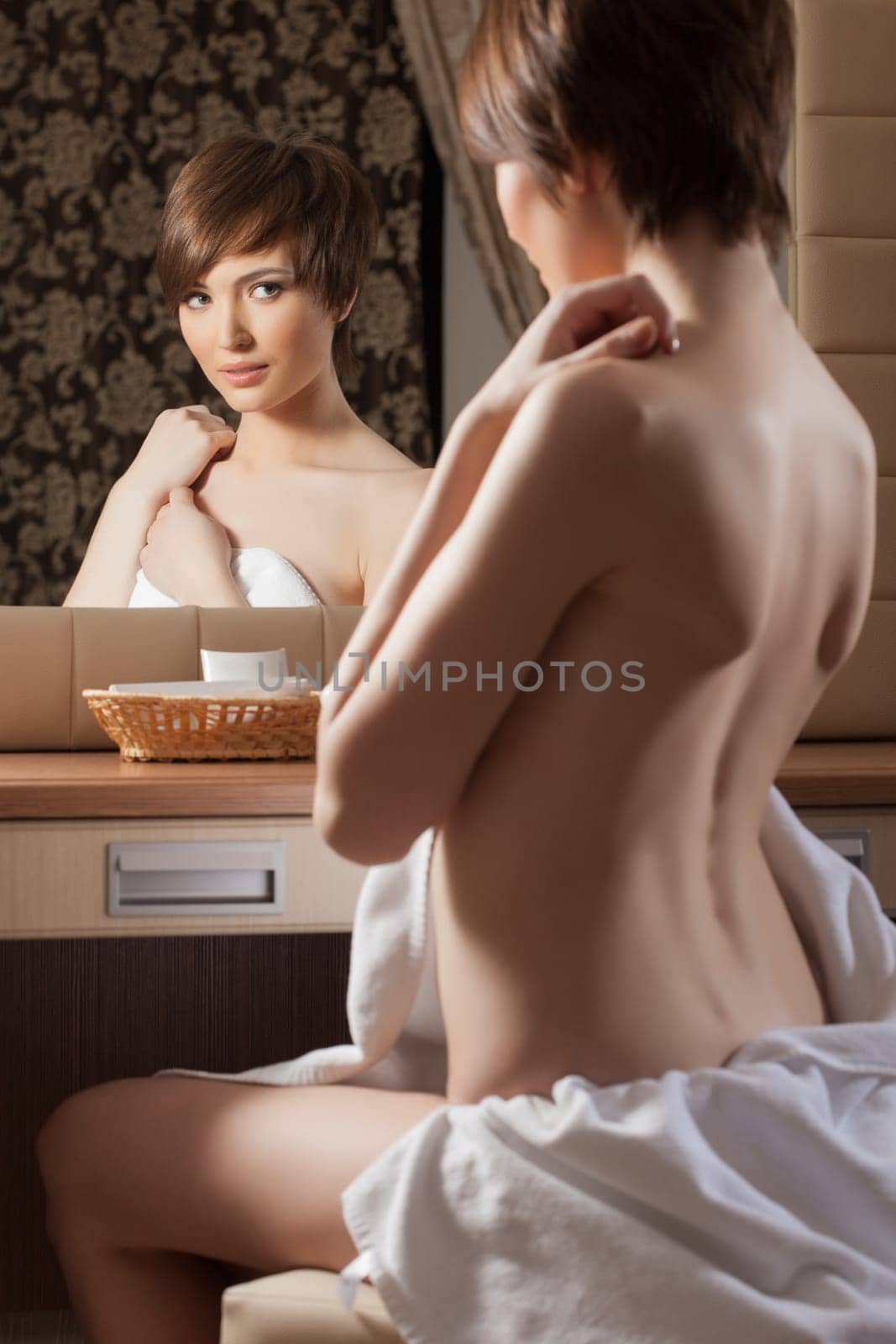 Beautiful girl posing naked near mirror, close-up