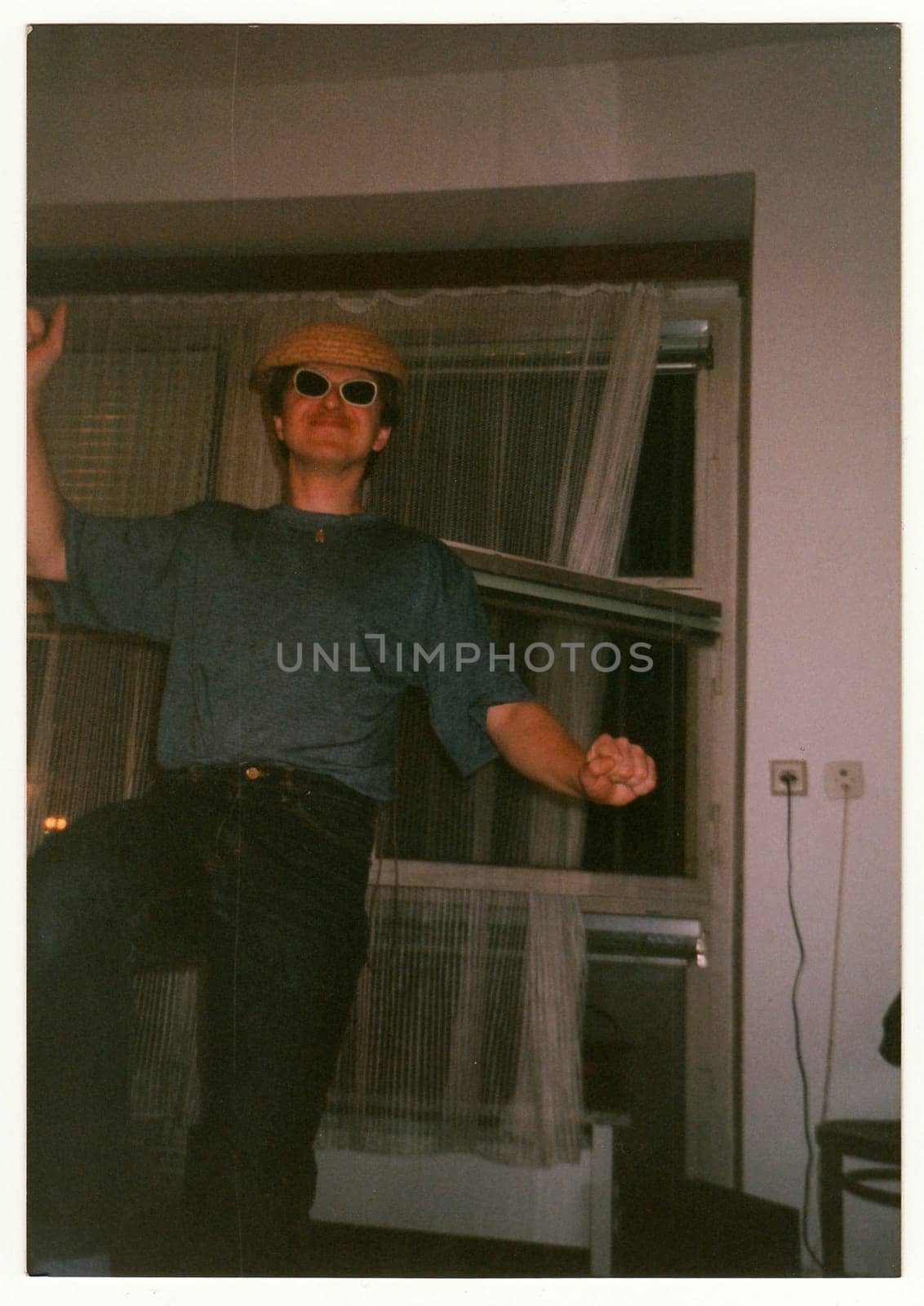 THE CZECHOSLOVAK REPUBLIC - CIRCA 1990s: Retro photo shows man dances at the home party.