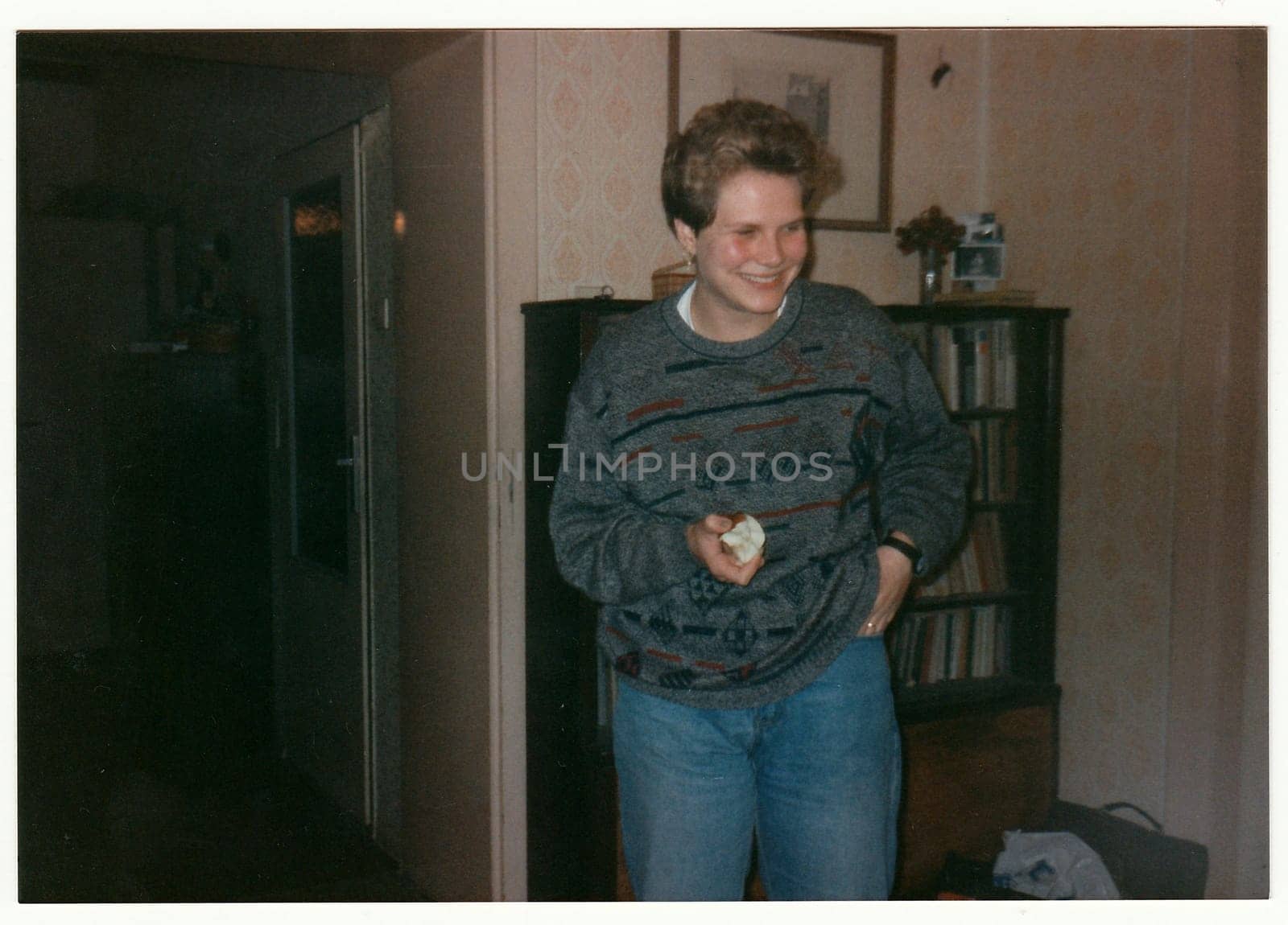 THE CZECHOSLOVAK REPUBLIC - CIRCA 1990s: Retro photo shows girl smiles at the home party.