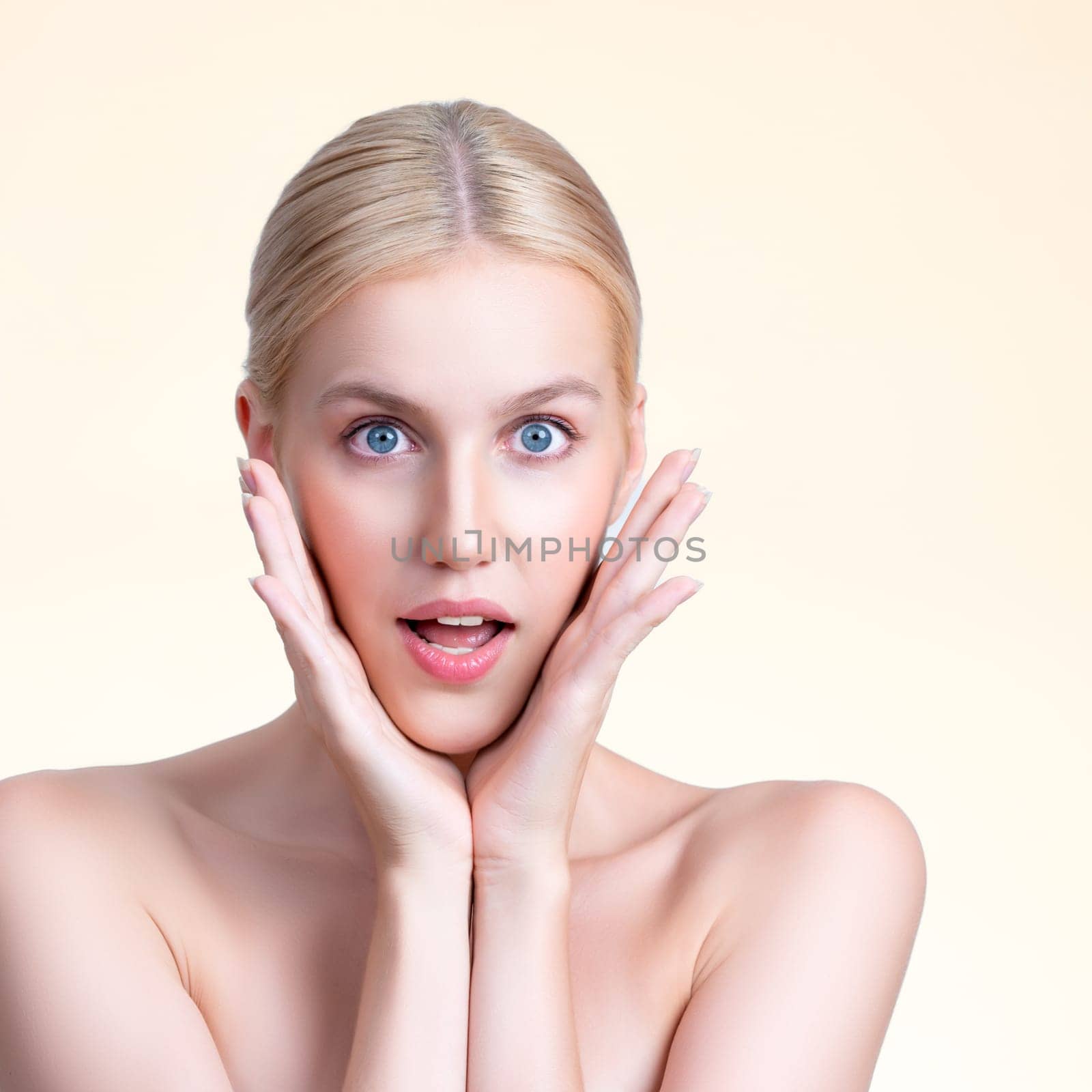 Personable beautiful woman with perfect smooth clean skin and natural soft makeup in isolated background. Hand gesture with expressive surprise facial expression for beauty care and spa concept.