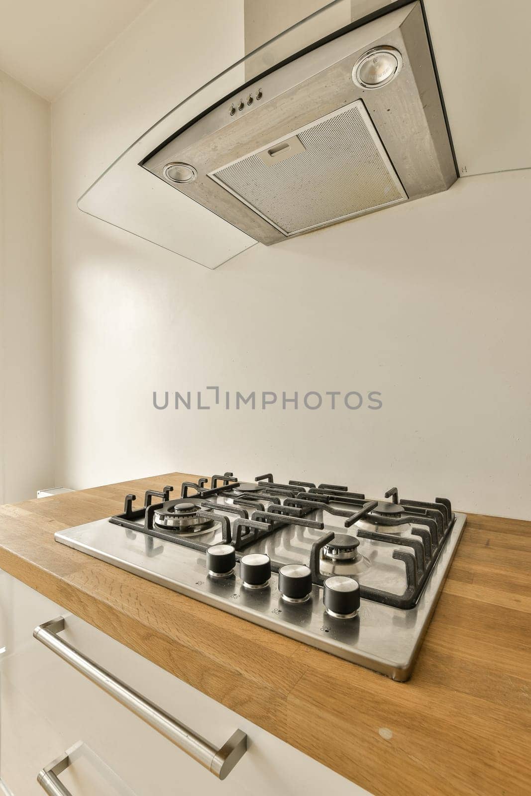 a kitchen with wood counter tops and stove hood over the range in this photo is taken from an angle to show how it's