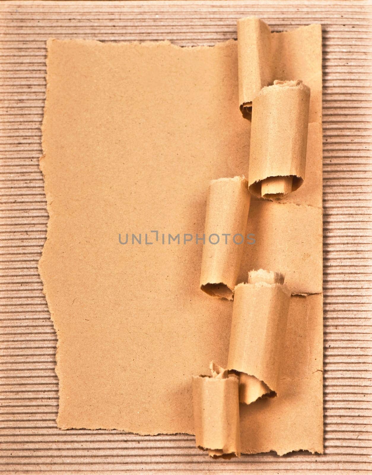 old textured cardboard sheet with torn edges wooden background