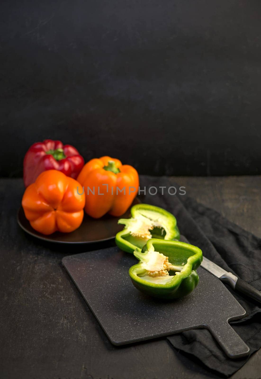 sweet pepper, red, green, yellow pepper on black background, full depth of field by aprilphoto