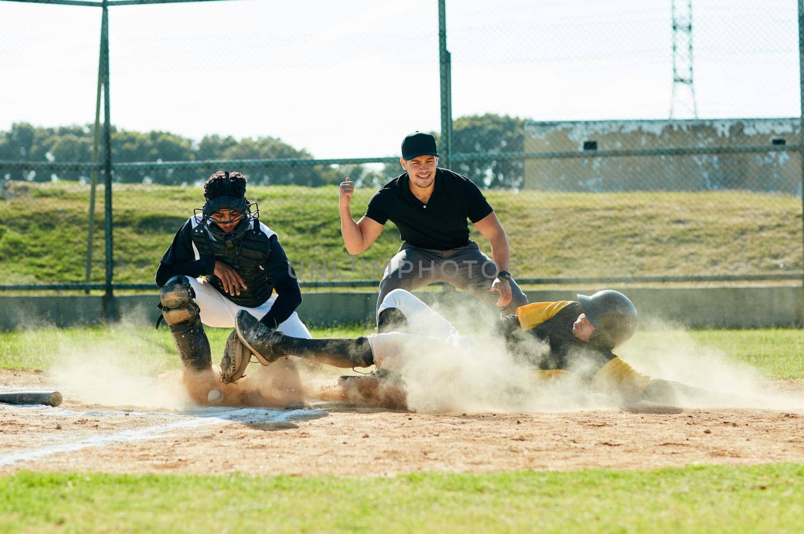 Sliding into base is his thing. Full length shot of a young baseball player reaching base during a match on the field
