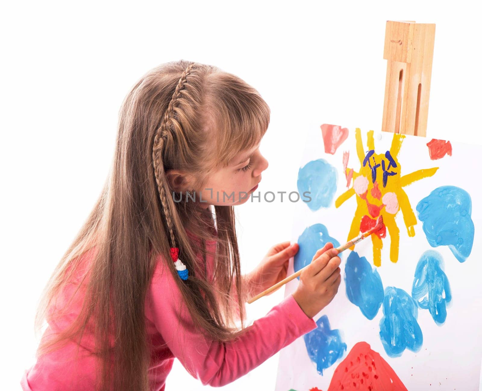 girl draws a house and the sun. artist kid girl painting over white background by aprilphoto