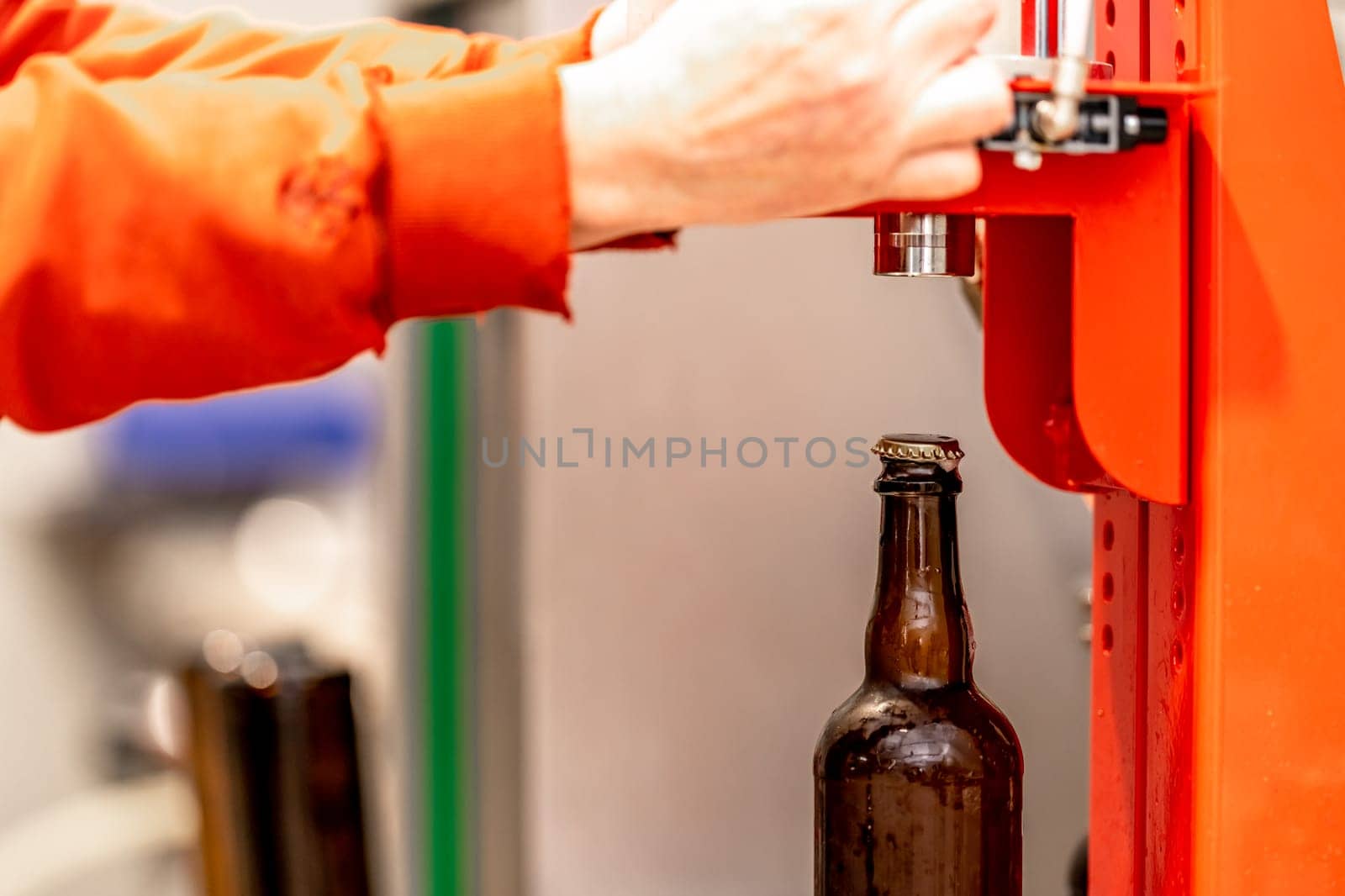mechanical capping of beer bottles in the brewery by Edophoto