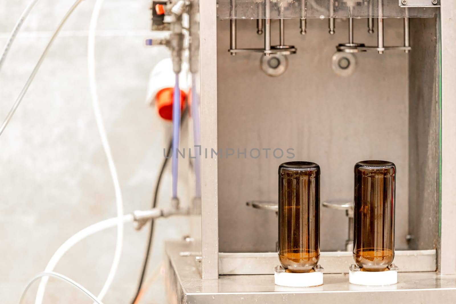 machine for washing and filling glass bottles with beer by Edophoto