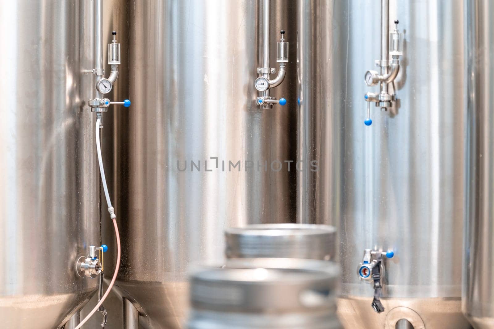 stainless steel tanks for brewing beer in a brewery. High quality photo