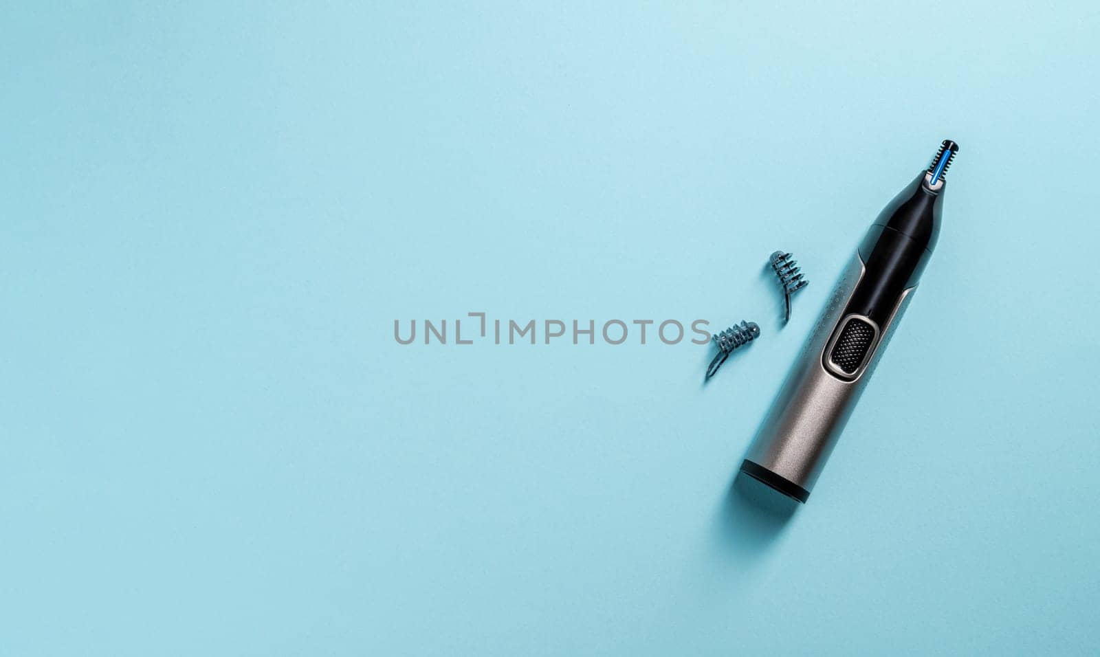 Top view of nose and ear hair trimmer isolated on blue background