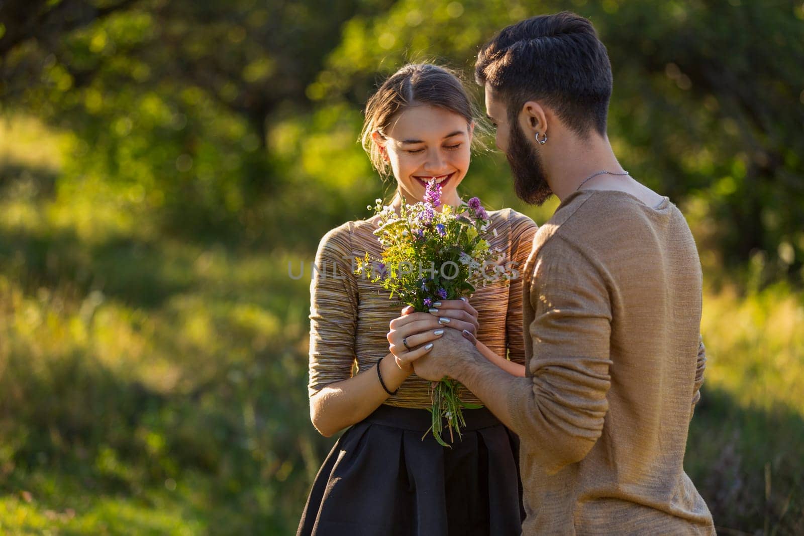 man giving wild flowers to his girlfriend
