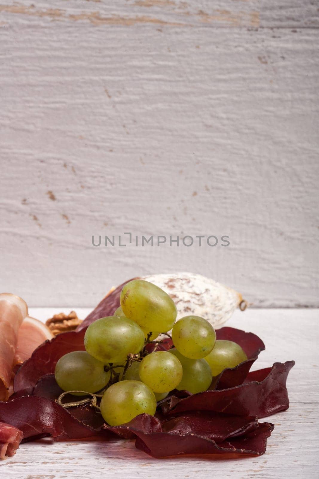Antipasto appetizer on white wooden background. Healthy lunch