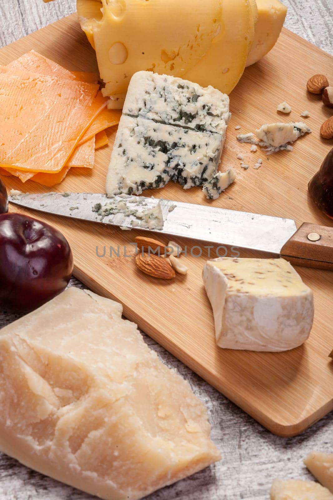 Healthy food. Differet type of cheese on wooden background by DCStudio