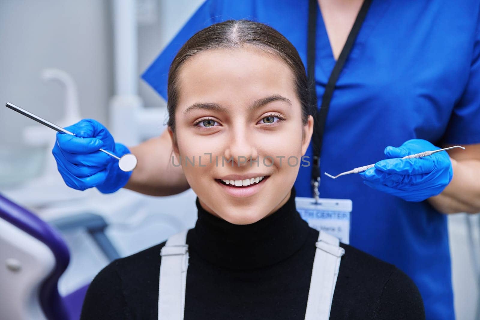 Young teenage female on dental examination treatment in clinic by VH-studio