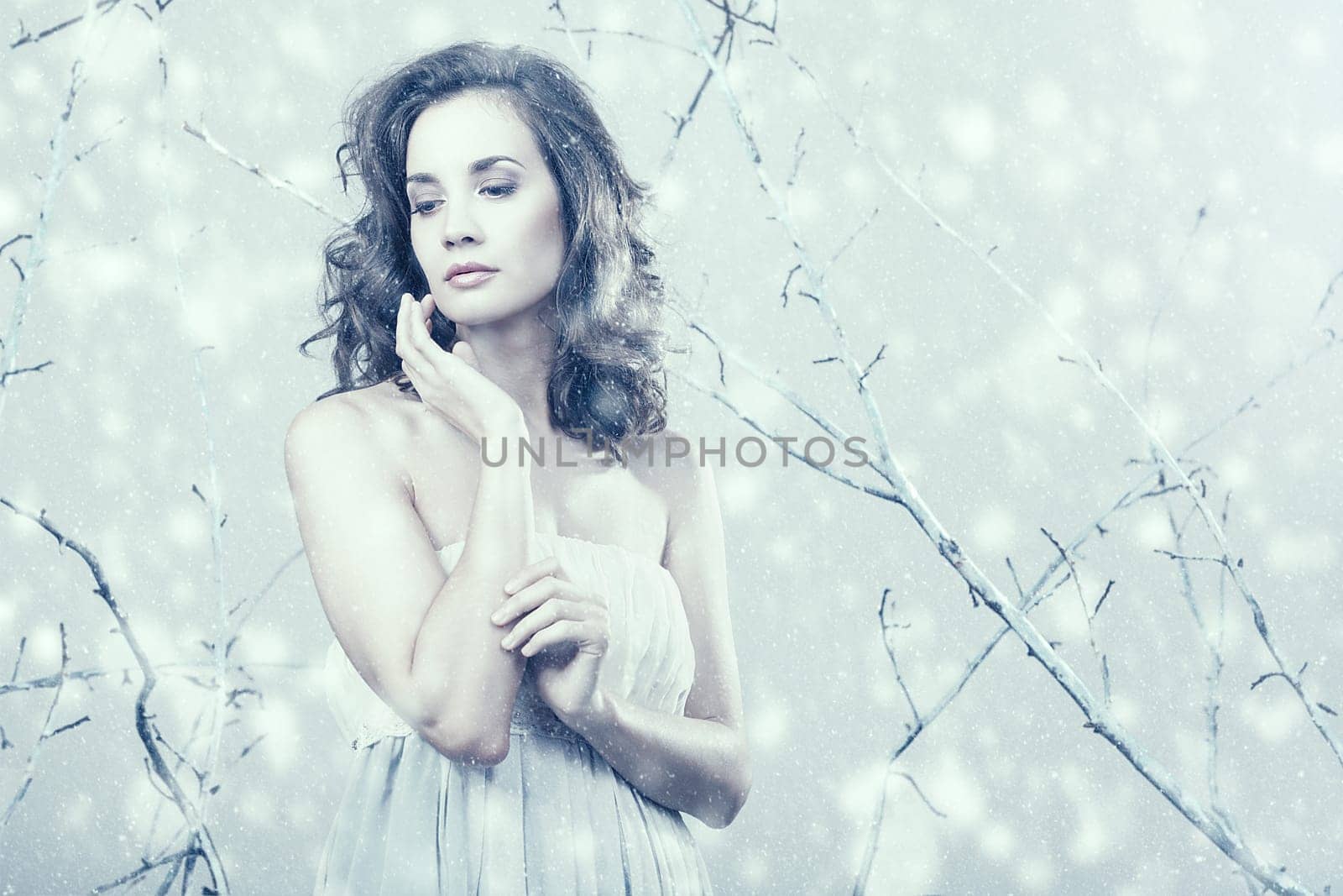Romantic girl looking away in dress on winter fantasy set up in studio photo. Romantinc and seasonal. Beauty and fashion. Elegance and dream