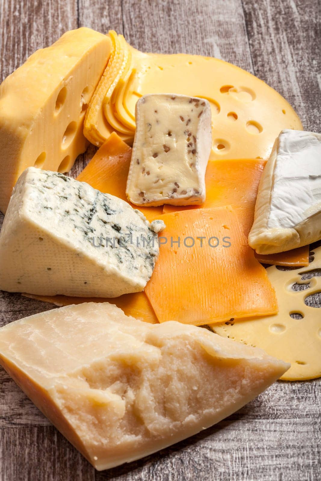 Healthy food. Differet type of cheese on white wooden background.