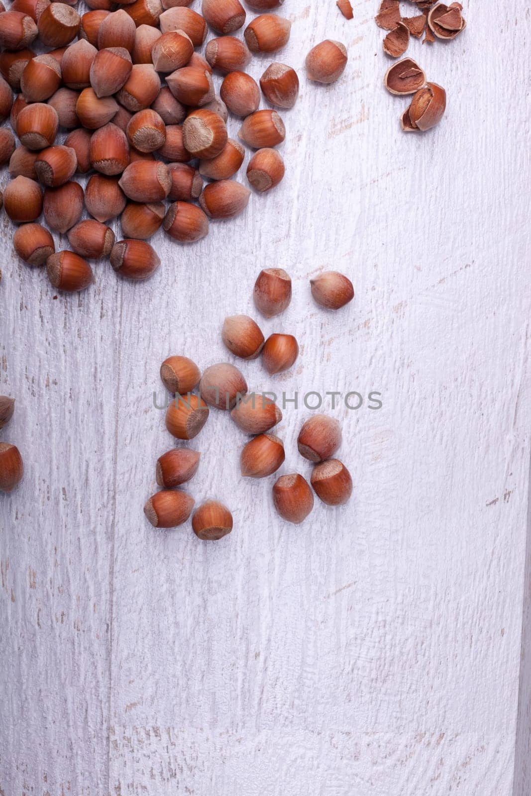 Hazelnuts on wooden background by DCStudio